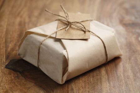 chocolate wrapped with paper as a gift on wood tableの写真素材