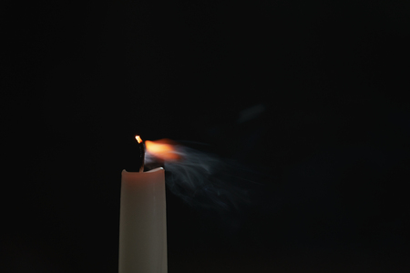 tall candle blown off in the dark environment, shallow focusの写真素材