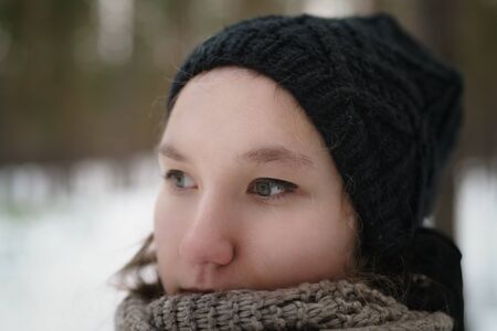 teenage girl closeup portrait in winter pine forest, shot wide open