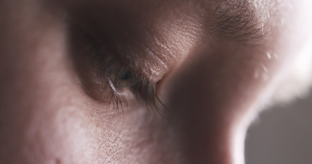 Closeup of teenage girl without makeup looking down and doing something, 4k photoの写真素材
