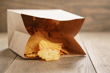 rippled potato chips with paprika in paper bag, shallow focusの写真素材