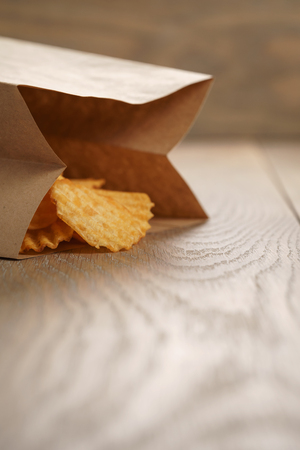 rippled potato chips with paprika in paper bag, with copy spaceの写真素材
