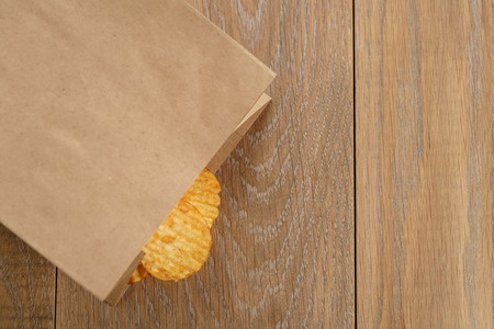 rippled potato chips with paprika in paper bag, with copy spaceの写真素材