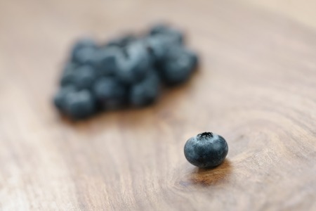 fresh garden blueberries on wood table, closeup photoの写真素材
