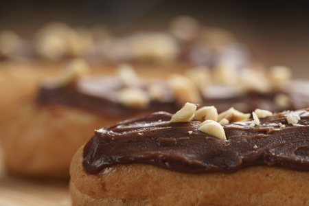 traditional french eclairs with chocolate and hazelnuts, shallow focus
