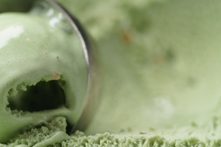 scooping natural pistachio ice cream closeup, shallow focusの写真素材