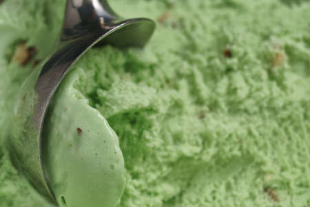 scooping natural pistachio ice cream closeup, focus on scoopの写真素材