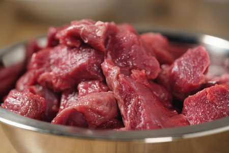raw beef in bowl closeup, shallow focus