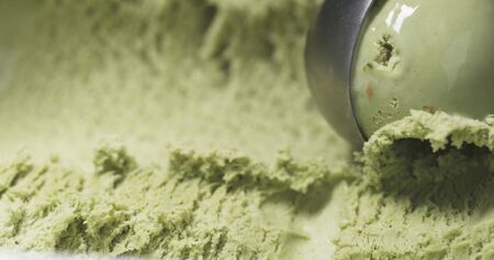 pistachio ice cream being scooped close up, wide photoの写真素材
