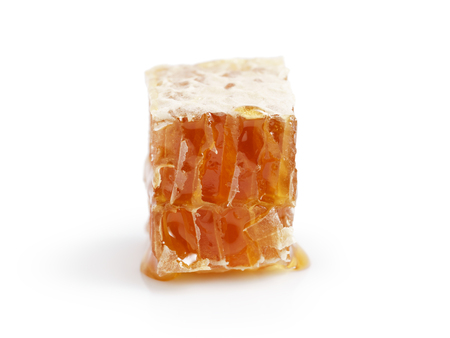 small piece of honeycomb isolated on white backgroundの写真素材