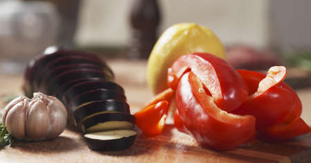 fresh vegetables, eggplant, bell pepper, lemon, garlic and rosemary wide photoの写真素材