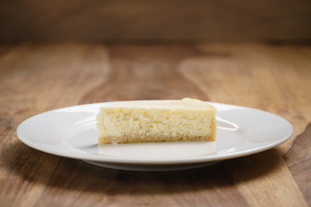 cheesecake on plate on wood table, shallow focusの写真素材