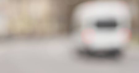 Bokeh blur shot of town street with traffic in spring day, wide photoの写真素材