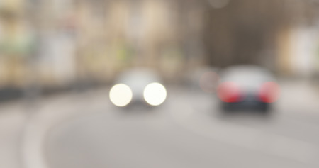 Bokeh blur shot of town street with traffic in spring day, wide photoの写真素材