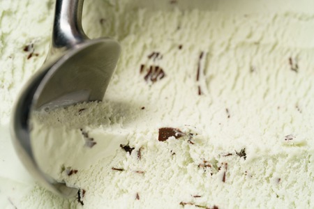mint ice cream with chocolate chips scooped, shallow focus