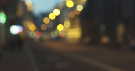 still blur background of night city with moving cars and walking people, wide photoの写真素材