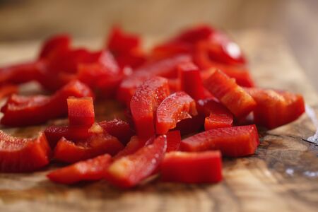chopped red bell pepper on cutting board, shallow focusの写真素材