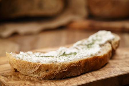 ricotta cheese with herbs on fresh rustic breadの写真素材