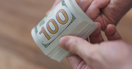 closeup man hands flipping dollarsの写真素材