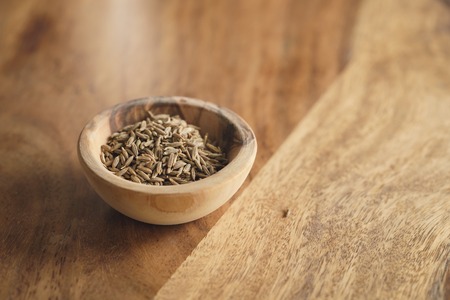 cumin zira seeds in wood bowl on tableの写真素材