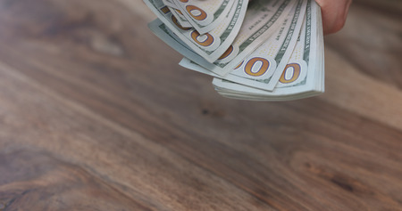 closeup man hands flipping dollarsの写真素材