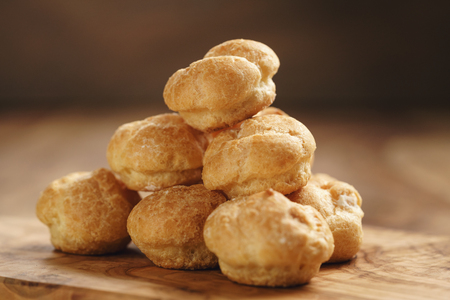 profiteroles on olive board closeupの写真素材