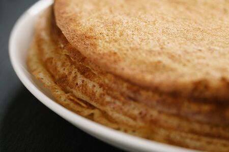 homemade blini stack on plate on slate board, traditional russian foodの写真素材