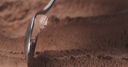 closeup scooping chocolate ice cream with spoonの写真素材