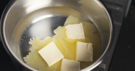 melting butter in pot close up photoの写真素材