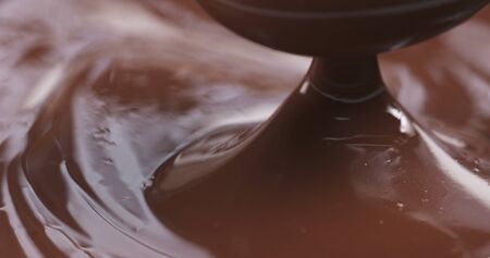 pouring melted premium dark chocolateの写真素材