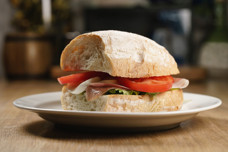 ciabatta sandwich with speck, mozzarella and vegetablesの写真素材