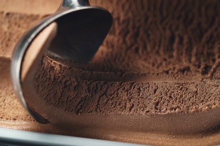 closeup scooping chocolate ice creamの写真素材