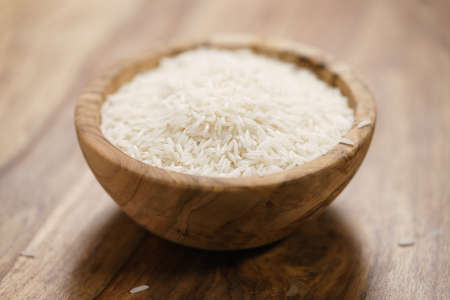 dry basmati rice in wood bowl on tableの写真素材