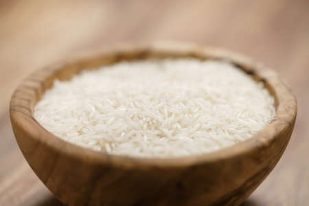 dry basmati rice in wood bowl on tableの写真素材