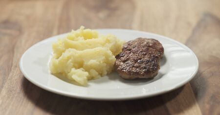 mashed potatoes with cutlets on white plate, wide photoの写真素材