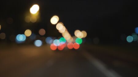 blurred background through windshield in city at nightの写真素材