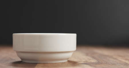 closeup of white bowl on wood table