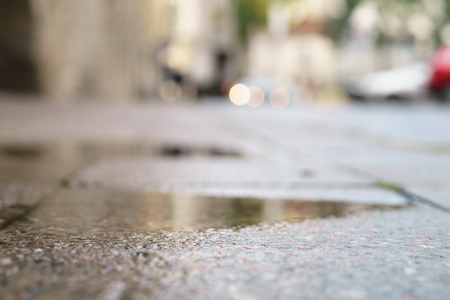 low angle shot of wet pavement in Tallinn with shallow focusの写真素材