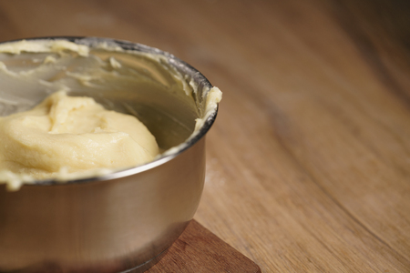 choux dough in saucepan on wood tableの写真素材