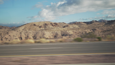 Driving plate side view moving through desert in car with motion blurの写真素材
