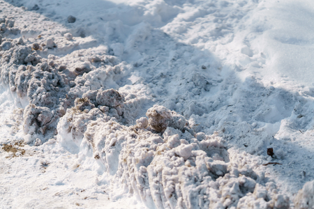 sidewalk in town after snowfall with morning sunの写真素材