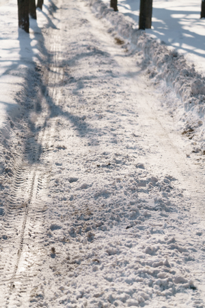 sidewalk in town after snowfall with morning sunの写真素材