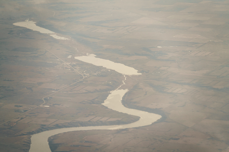 view of fields and rivers from airplane flying over USA