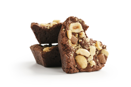 Homemade heart shaped chocolate cookies with hazelnuts and chocolate pieces isolated on whiteの写真素材