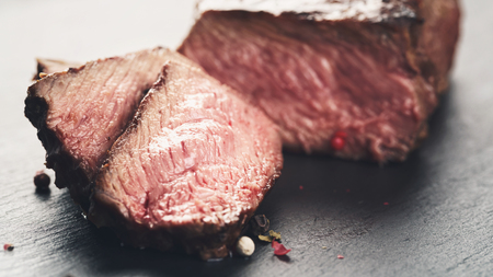 entrecote beef steak sliced on slate boardの写真素材