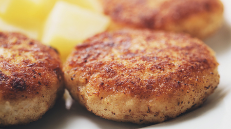 prepared fried fish cakes with boiled potatoes