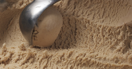 closeup hazelnut praline ice cream scooping