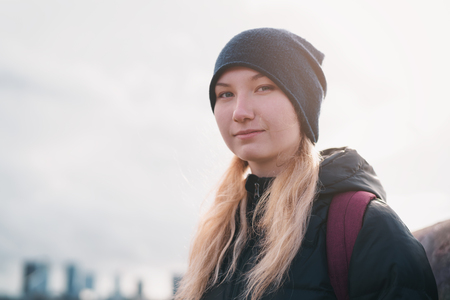 urban portrait of teen girl walking in the city in autumn or springの写真素材