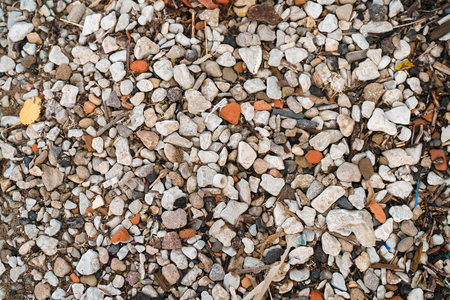 pebble beach with small pieces of wasteの写真素材