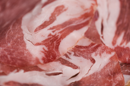closeup cured italian coppa on olive wood boardの写真素材